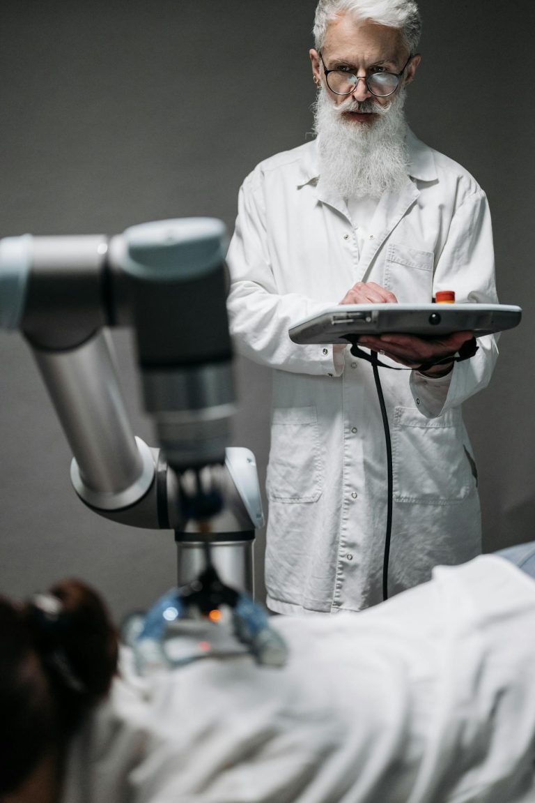 Scientist in a white coat operating a robotic arm in a modern laboratory environment.